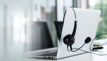 Laptop computer with headset used for a webinar